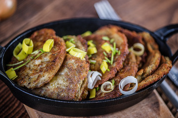 Wall Mural - traditional hanukkah fried potato pancakes in black iron cast pan 