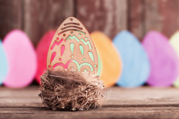 Easter paper eggs on wooden background