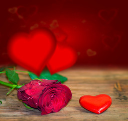 Wall Mural - Red hearts on wooden table against defocused lights