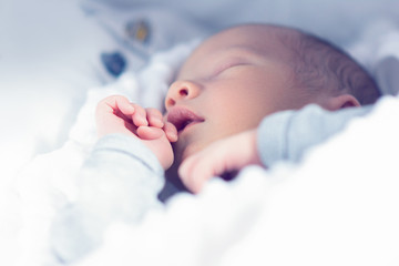 one month old baby boy sleeping. shallow depth of field, selective focus, pastel colors
