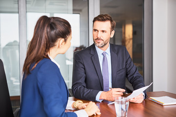 Recruiter during business job interview in office with female candidate