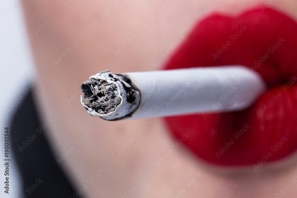 red lips smoking cigarette red lips smoking a cigarette close up Stock Photo