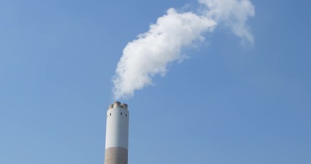 Wall Mural - Factory plant smoke stack over blue sky