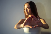 Woman Hands Together Symbolizing Prayer And Gratitude. Mudra. Woman Blurred On Background, Focus On Hands