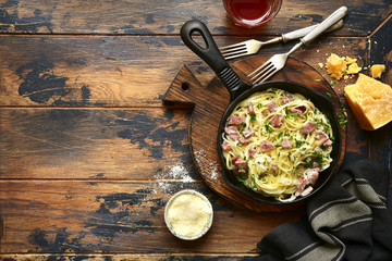 Wall Mural - Traditional italian dish spaghetti carbonara with bacon in a cream sauce.Top view with copy space.