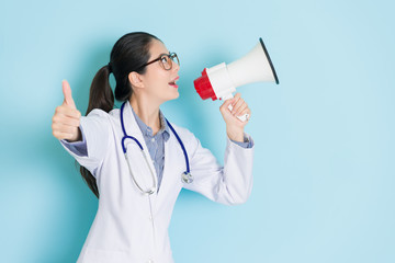 happy attractive woman doctor using loudspeaker