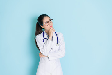 Wall Mural - beauty female doctor standing in blue background