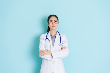 Wall Mural - hospital doctor standing in blue wall background