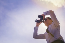 Close Up Of Businessman Looking Through Binocular. Searching For Goal Concept. Low Angle View.