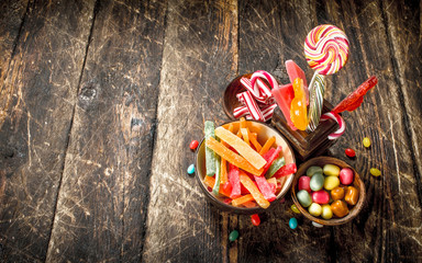 Wall Mural - Different sweet candy in bowls.