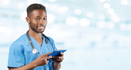 Poster - African american doctor with a stethoscope standing against blurred background