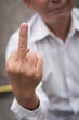 angry upset senior old man giving middle finger rude obscene gesture