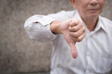 Wall Mural - angry senior giving thumb down gesture, unhappy upset frustrated old man