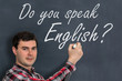 Do you speak English? Man with chalk writing on blackboard