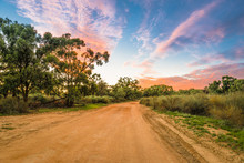Rural Australian Landscape With Colorful Clouds Ans Dirty Gravel Road In Outback Of Australia At Sunrise/sunset