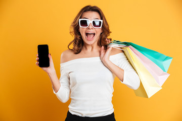 Canvas Print - Happy young lady showing display of phone.