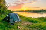 Fototapeta Natura - Camping tent in a camping in a forest by the river
