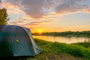 Wall Mural - tourist tent in a camping on the river bank