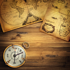 Old vintage retro compass on ancient map background. Travel geography navigation concept background.