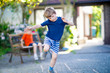 © Irina Schmidt - Two little school and preschool kids boys playing hopscotch on playground