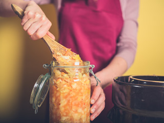 Young woman making kimchi