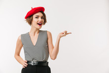 Portrait Of A Cheerful Woman Wearing Red Beret Pointing