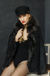 © tatiana1987 - portrait of attractive lady in a black cap and a sheepskin coat with a fur collar . Perfect makeup, red lips and blue eyes