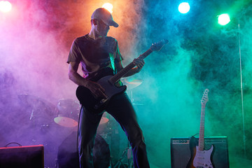 Wall Mural - The guitarist performs on stage.