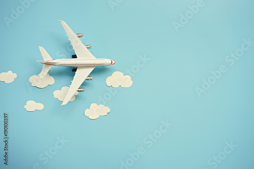 Cuadros en Lienzo Flat lay design of travel concept with plane and cloud on blue background with copy space