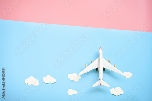 Photographie Flat lay design of travel concept with plane and cloud on blue and pink background with copy space