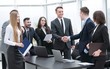 © ASDF - handshake business partners at a meeting in the office