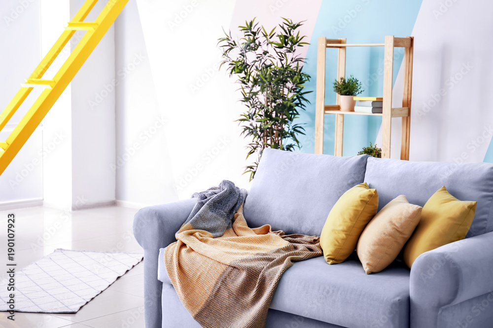 Living room interior with comfortable couch and soft pillows