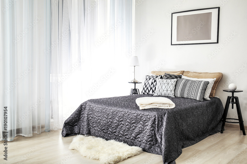 Stylish interior with comfortable bed and soft pillows