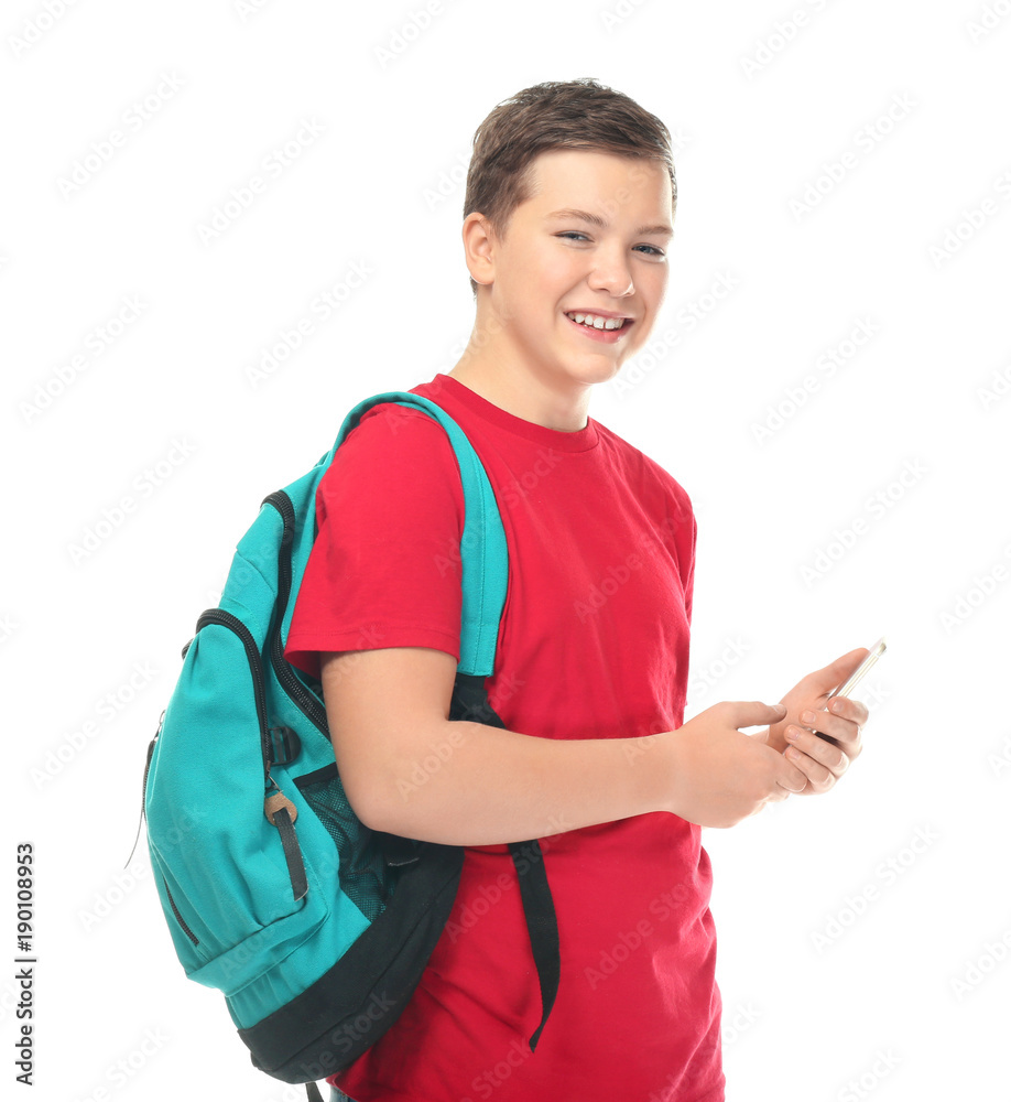Teenage boy with backpack and smartphone on white background