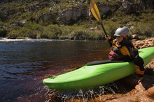 Woman Kayaking In River