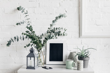 Wall Mural - houseplants with blank chalkboard in front of white brick wall, mockup concept