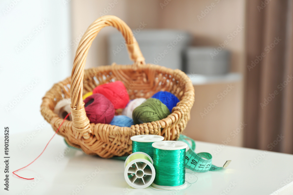Green sewing threads with crocheting clews on table indoors