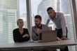 © kanashkin - The business people sit at the table and work in the office.