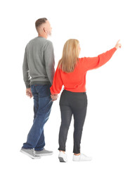 Mature couple in casual clothes walking on white background