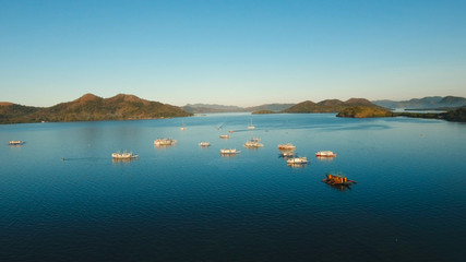 Naklejka na meble Seascape tropical bay with boats, surrounded by mountains on the island. Aerial view: Beautiful tropical sea bay. Scenic landscape with mountain islands and blue lagoon. Coron, Philippines,Palawan