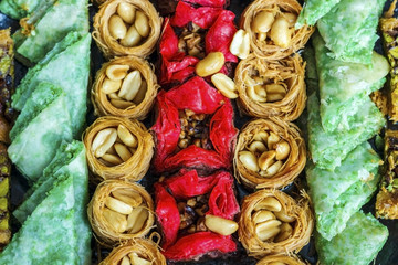 Turkish dessert. Oriental sweets with nuts and honey on a wooden background.