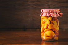 Preserved Fruit In Jar, Compote Of Peaches. Homemade Conserved Fruits In Glass On A Wooden Table. 