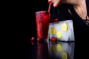 Cocktail with strawberry for young girl with red lips.