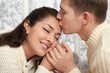 © soleg - couple portrait near window with winter season, dressed in white, face closeup, love and holiday concept