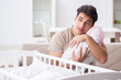 © Elnur - Young father enjoying time with newborn baby at home