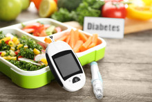 Digital Glucometer, Lancet Pen And Lunch Box With Vegetables On Table. Diabetes Diet