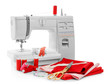 Modern sewing machine with threads and fabrics on white background