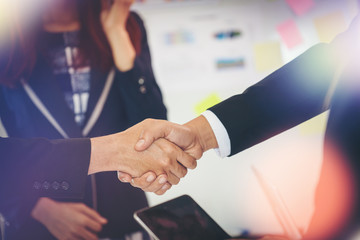 Wall Mural - Business people shaking hands while sitting at the working place, Finish success business good deals meeting