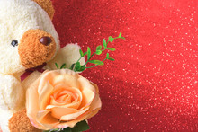Teddy Bear With Flowers In Valentines Day On Red Glitter Bokeh Lights Blurred Abstract Background.