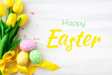 Fototapeta Tulipany - Happy Easter. Congratulatory easter background. Easter eggs and flowers.